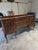 This sideboard represents the American Colonial Revival movement of the early 20th century, when furniture makers looked...