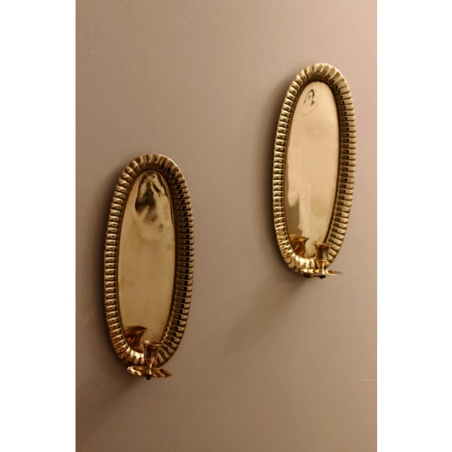 Made in Sweden Pair of exquisite repoussé Swedish brass wall sconces showcasing captivating hammered style. Meticulously...