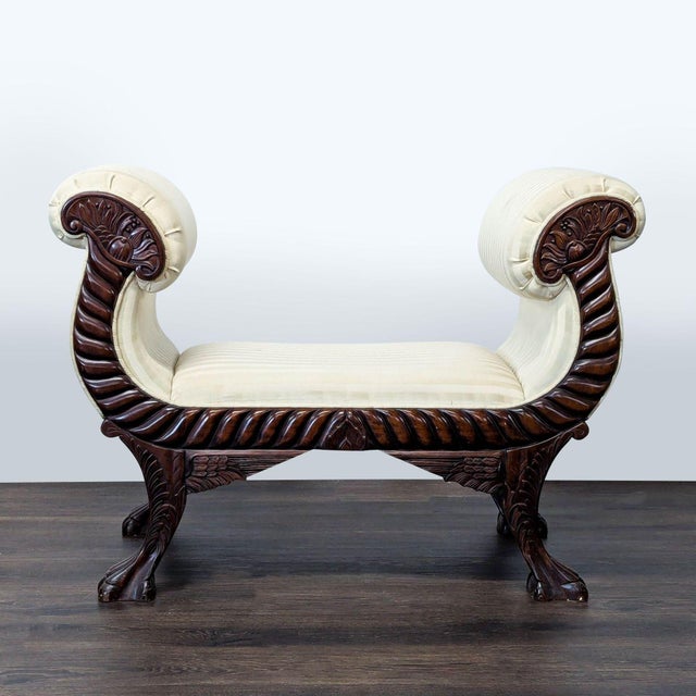 American classical carved mahogany window bench seat has double scrolled cornucopia arms, carved wings on legs, and paw...