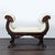 American classical carved mahogany window bench seat has double scrolled cornucopia arms, carved wings on legs, and paw...