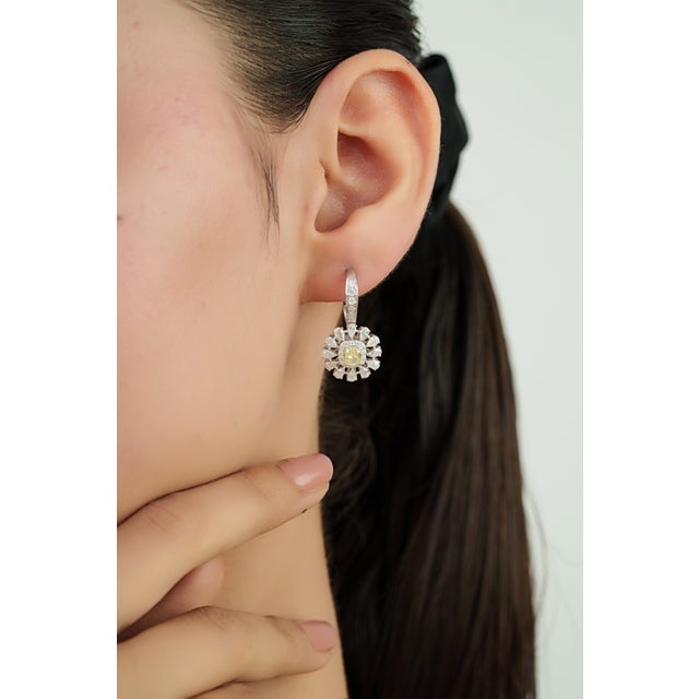 These Art Deco-inspired drop earrings feature 2.29 carats of fancy yellow and white diamonds set in 18K white gold. The...