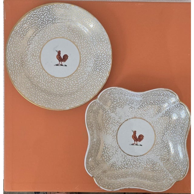 This antique set of seven English porcelain plates includes six round plates and one matching square plate, attributed to...