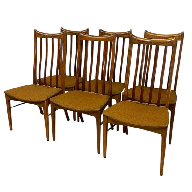 This set includes six matching vintage dining chairs in a clean, mid-century modern style. Each chair features a tall,...