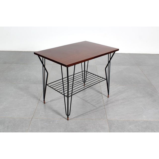 Beautiful coffee table with a geometric iron rod frame and teak wood top. Scandinavian production from the 1960s. Wear...