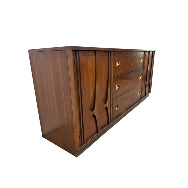 Showcasing one of the most iconic designs of the mid-century era, this circa 1960s Broyhill Brasilia walnut 9-drawer...