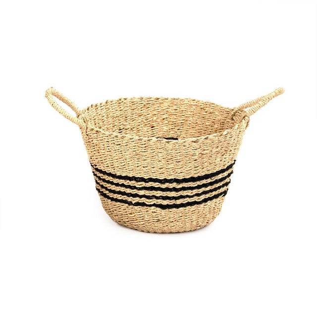 Woven handmade seagrasss basket with a dark brown accent around basket.