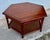 Elegant vintage hexagonal coffee table crafted from solid wood with a warm, satin mahogany finish. The tabletop features a...