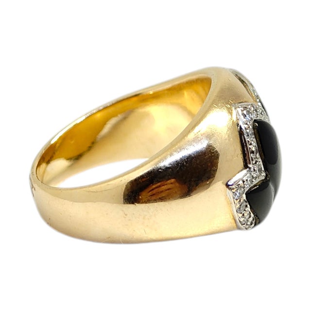 Vintage graduating domed band crafted in 14K yellow gold, featuring a striking black onyx design. The onyx is hand carved...