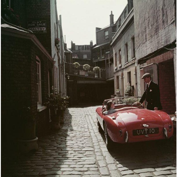 Sports Car Couple 1955 John Bryant with his AC sports car in Kinnerton Place, London SW1. His passenger is Margaret...