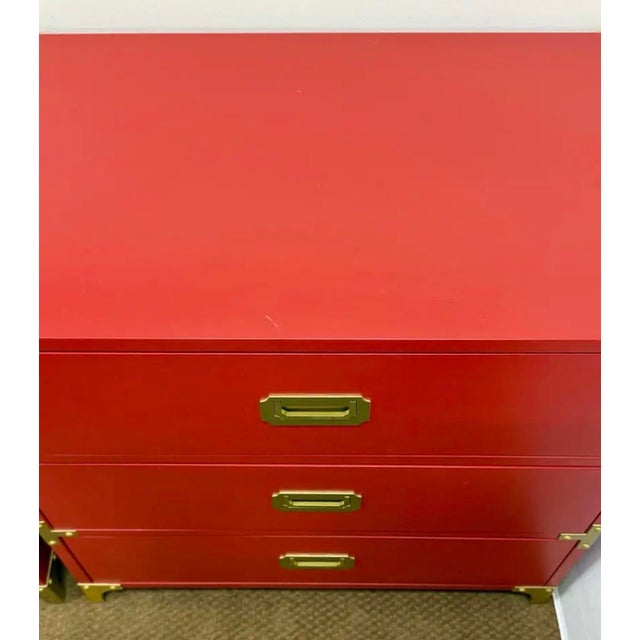 Stunning campaign style chest in a bold red finish, accented with handsome brass corner and handle detailing for a...