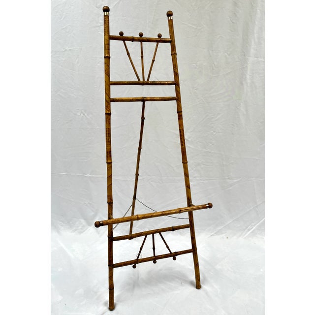 Vintage scorched bamboo easel with brass accents. Beautiful patina with interesting scorching patterns. The perfect...