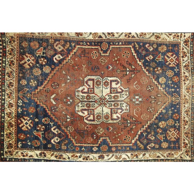 This antique handmade Shiraz rug was manufactured ca. 1880 in Persia (Iran today). The rug is in traditional deeply brown...