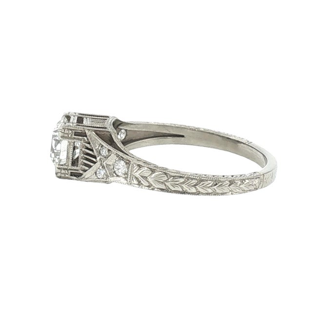 An Art Deco-style hand-engraved ring showcases a repurposed 1.05-carat European-cut natural diamond, slightly included...