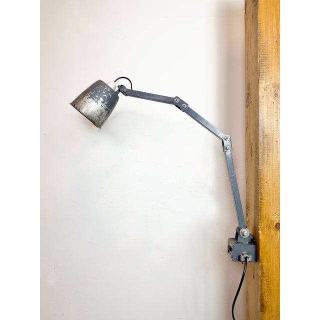 This vintage Industrial adjustable wall lamp was produced by Memlite in United Kingdom during the 1960s. The lamp has a...