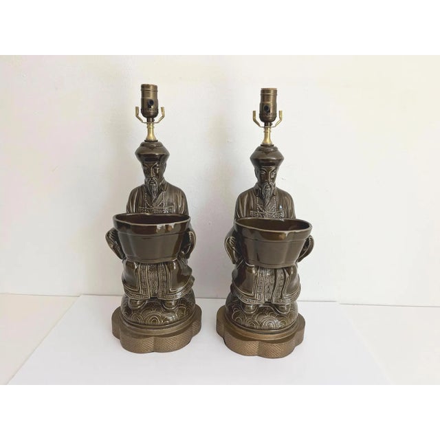 Gorgeous big pair of mid century glazed olive green ceramic Asian scholar lamps in ceremonial robes holding open planter...