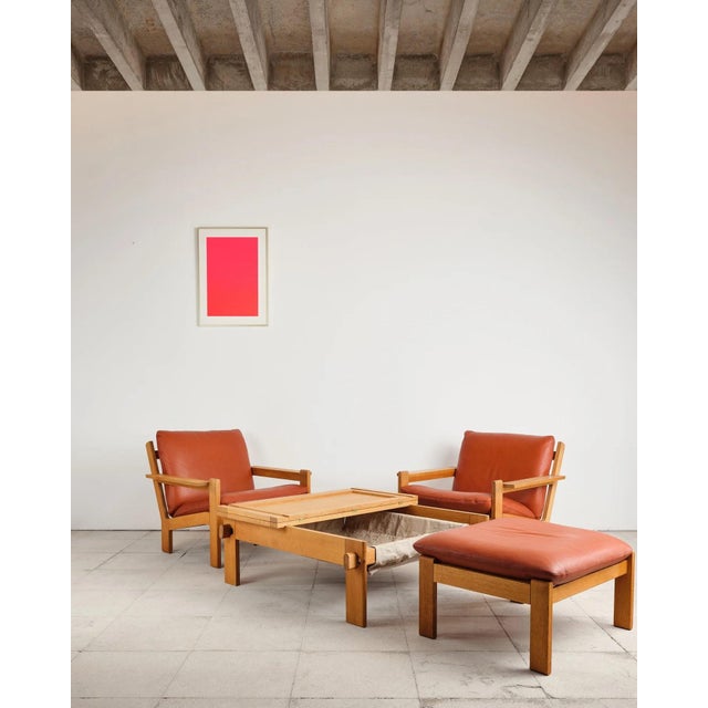 An exceptionally rare, complete lounge set by Tage Poulsen, consisting of two lounge chairs, a matching ottoman, and the...