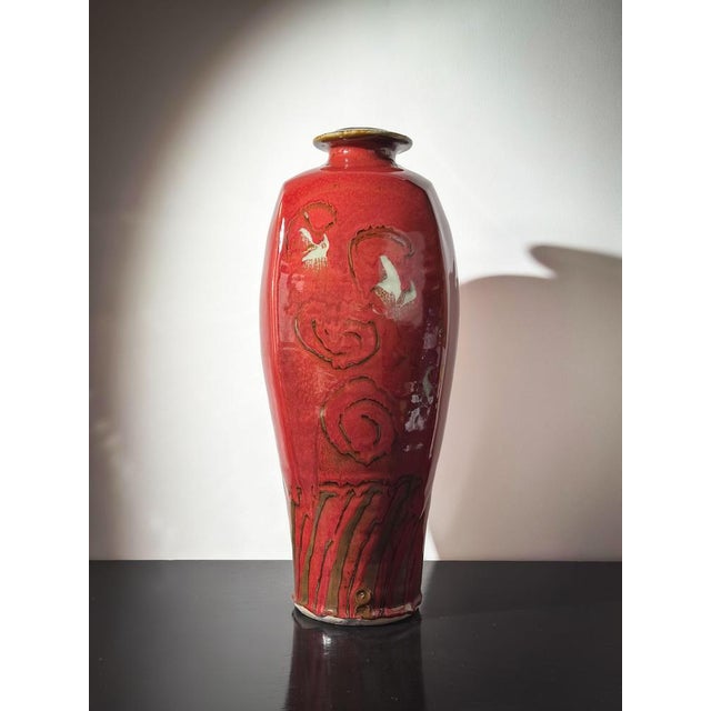 This large red glazed ceramic vase, hand-thrown by British studio potter David Frith at Brookhouse Pottery circa 1980s, is...