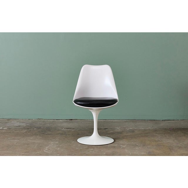A nice set of recent Knoll Saarinen Tulip chairs with black leather seat cushions. The chairs and cushions are are labeled...