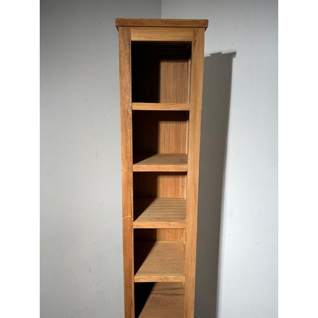 This elegant tall cabinet in solid teak wood combines functionality with a warm, timeless aesthetic. Its slim and vertical...