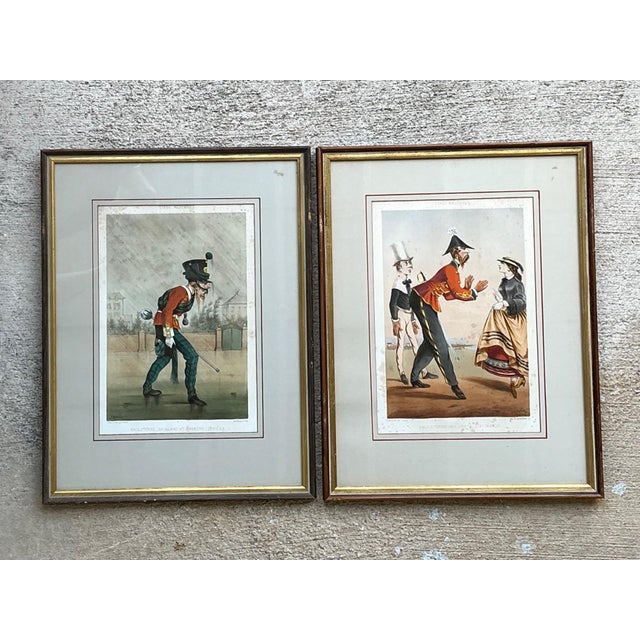 This charming pair of antique military caricature prints brings together historical subject matter and whimsical artistic...