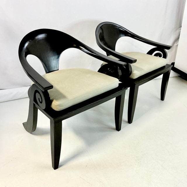Vintage Home is pleased to present this stunning pair of hand-carved espresso stained teak curled arm Spoon Chairs. The...