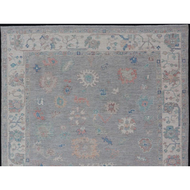 Measures: 7'10 x 9'8 All Over Modern Floral Oushak with A Light Blue-Gray Field and Border With Color. Keivan Woven Arts;...