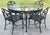 Uniquely classic vintage outdoor dining table with four chairs featuring hummingbird motif. Round black aluminum table...