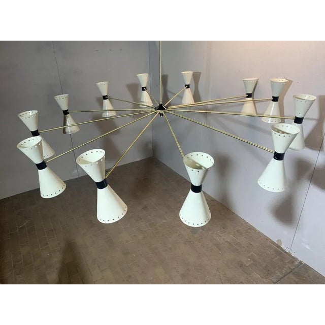 Stilnovo chandelier of two meters in diameter, 20 light points, 10 upward and 10 downward, completely made of brass, the...