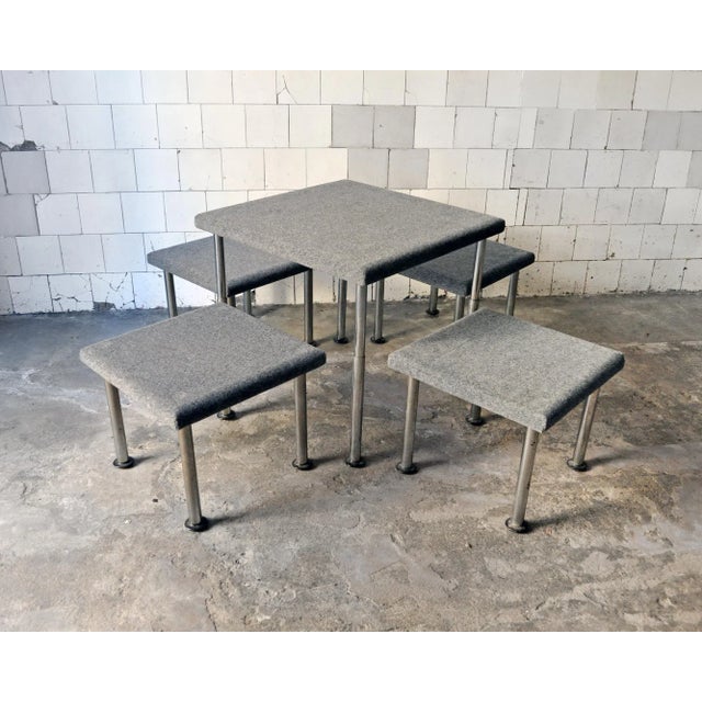 Table with four stools with chromed metal legs, top coated tapisom. the periscopic table legs allow him to have both the...