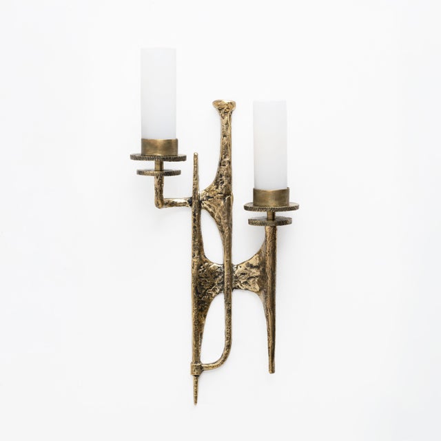 Pair of brutalist cast bronze wall lamps, maison arlus style, in the style of felix agostini. this wall lamp is in gilded...