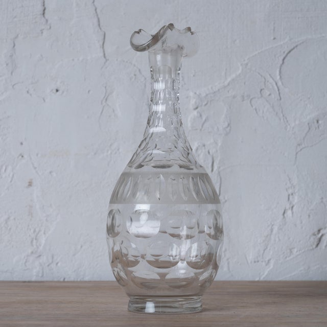 An antique cut crystal double spout decanter. 3 ¾ inches wide by 9 inches tall .