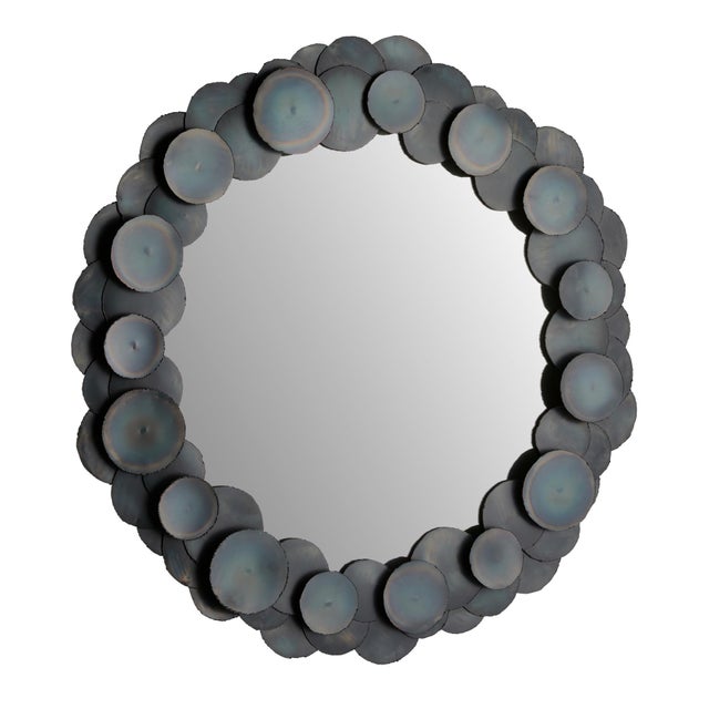 This Brutalist-inspired mirror takes seventy iron discs to construct the rounded frame. Each hand-cut disc of burnt iron...