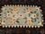 American Folk Art from the late 1800s. Two bouquets of flowers in the tradition of Persian Senneh design on a cream field...