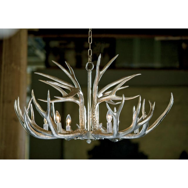 Wildlife gone glam. The resin Antler chandelier wears a metallic Ambered Silver Leaf to bring a beautiful sheen to a...