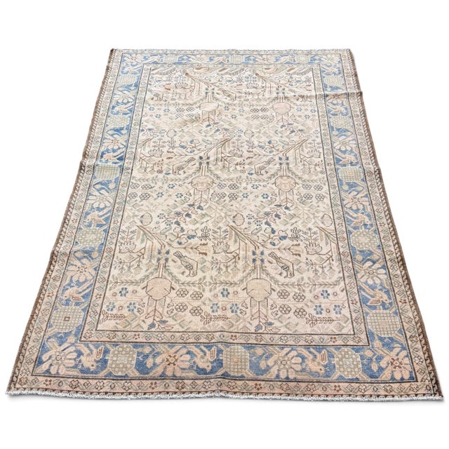 An exceptionally charming antique rug that feels like a little garden captured in wool. Its delicate allover floral design...