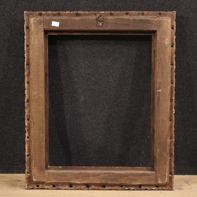 Mid 20th century Italian frame. Finely carved and gilded wooden piece featuring relief ornamentation, including turned...