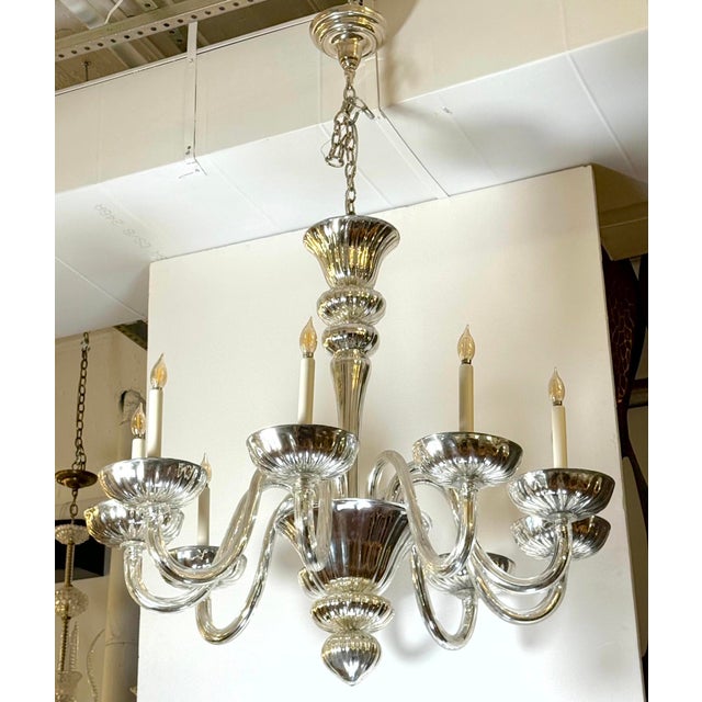 Modern style Italian mercury glass chandelier with nine arms and a chrome finish chain. This light requires nine E-12...