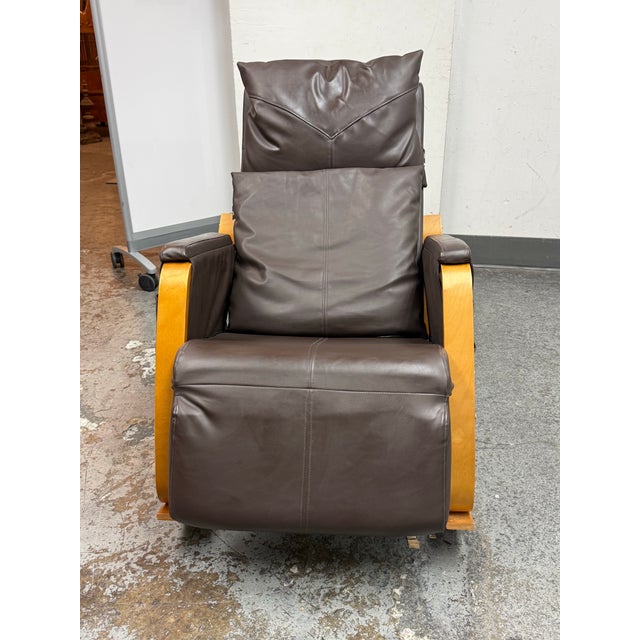 Design Plus Gallery presents a JXP Rocking Massage Chair. This chair has brown upholstered leatherette cushioning, a...