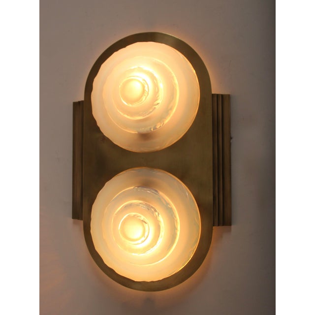 A pair of Petitot wall lights with a distinctive Art Deco motif in the opalescent glass shades. The solid brass brackets...