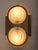 A pair of Petitot wall lights with a distinctive Art Deco motif in the opalescent glass shades. The solid brass brackets...
