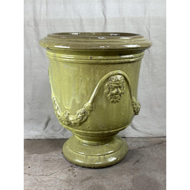 A monumental French Anduze style terracotta garden urn, richly glazed in a lustrous spring green. The classical form...