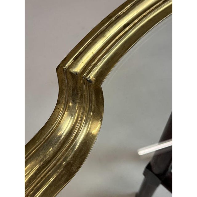 70s-80s coffee table. Glass top, framed with a brass rim. Resting on a wooden base. In very good condition. Light signs of...
