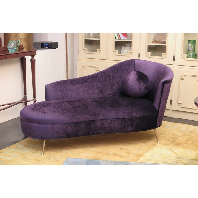 Italian mid-century daybed with feminine curves in purple velvet. This newly upholstered daybed features an upholstered...