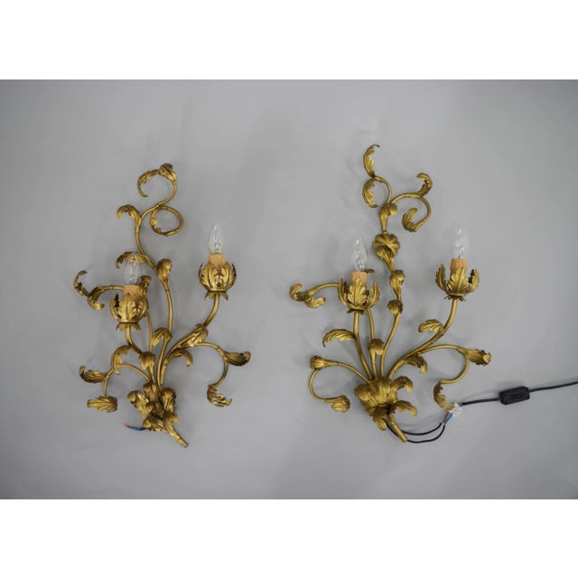 Set of two gilt wall lamps with floral motive. Made in Italy circa 1960s. Cleaned. Each lamp has two E12-E14 sockets US...