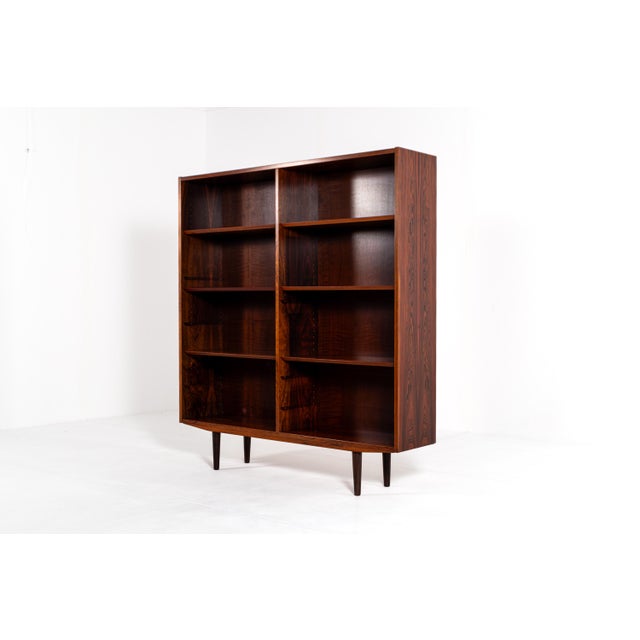 Beautiful Danish mid-century bookcase made of rich rosewood by Hundevad. This elegant piece features a clean and timeless...