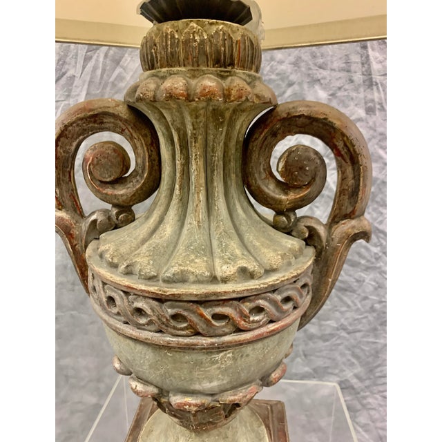 Carved urn from Florence, Italy wired as lamp with hand painted shade and antique finial, some parts gilded in silver.