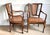 A pair of vintage Regency style mahogany armchairs in a rich wood grain with woven cane seats and backs, decorative...
