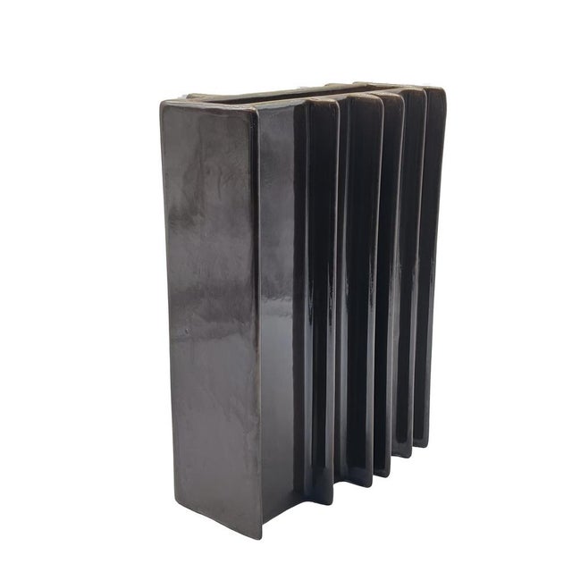 A sculptural vase in glossy brown glazed ceramic, designed by the renowned architect and designer Angelo Mangiarotti...