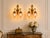 This distinctive pair of 1980s French Louis XVI–style wall sconces combines richly detailed bronze construction with a...