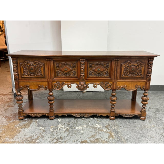 Design Plus Gallery presents a 1920's Tudor Revival Carved Walnut Console Server by Empire Manufacturing Company. This...